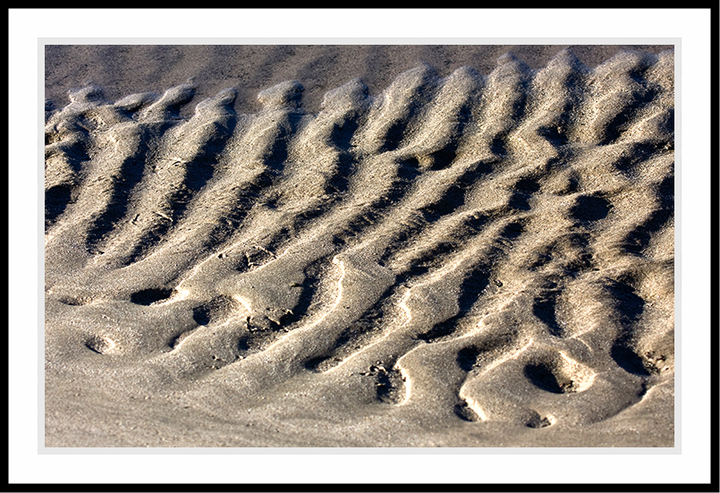 Sand with verticla shadows.